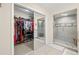 Bright bathroom featuring a walk-in closet and glass door shower with neutral tile and a small bench at 4213 Arborwood Ln, Tampa, FL 33618