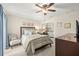 Well-lit bedroom featuring a cozy bed, stylish furnishings, and soft carpeting with a ceiling fan at 4213 Arborwood Ln, Tampa, FL 33618