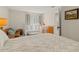 Comfortable Bedroom featuring a crib, changing table, and a cozy chair with natural light from the window at 4213 Arborwood Ln, Tampa, FL 33618