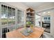 Bright dining area featuring a wooden table, modern shelving, and a sliding glass door to the outdoor patio at 4213 Arborwood Ln, Tampa, FL 33618