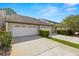 Attractive townhome featuring a one-car garage, driveway, and manicured landscaping at 4213 Arborwood Ln, Tampa, FL 33618