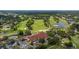 Aerial view showcasing the golf course and its clubhouse and parking area at 4213 Arborwood Ln, Tampa, FL 33618