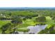 Scenic golf course with a pond featuring an island green in a lush green setting at 4213 Arborwood Ln, Tampa, FL 33618