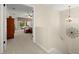 Hallway leading to the main bedroom, featuring neutral carpets and tasteful decor at 4213 Arborwood Ln, Tampa, FL 33618
