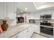 Bright kitchen features white cabinets, granite countertops, and stainless steel appliances at 4213 Arborwood Ln, Tampa, FL 33618