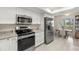 Modern kitchen features stainless steel appliances, white cabinets, and a cozy breakfast nook at 4213 Arborwood Ln, Tampa, FL 33618