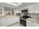 Modern kitchen with white cabinetry, stainless steel appliances, and granite countertops at 4213 Arborwood Ln, Tampa, FL 33618