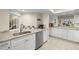 Updated kitchen with stainless steel appliances, white cabinets, and granite countertops at 4213 Arborwood Ln, Tampa, FL 33618