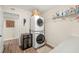 Well-equipped laundry room with stacked washer/dryer and a wine cooler at 4213 Arborwood Ln, Tampa, FL 33618