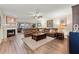 Inviting living room boasts a cozy fireplace, plush leather sectional, and an abundance of natural light at 4213 Arborwood Ln, Tampa, FL 33618