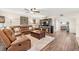 Open-concept living room featuring wood floors, a leather sectional, and a media center at 4213 Arborwood Ln, Tampa, FL 33618