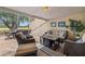 Inviting screened-in patio with outdoor seating, elegant decor, and views of the surrounding landscape at 4213 Arborwood Ln, Tampa, FL 33618