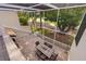 Spacious screened-in patio with a dining table and scenic views of a golf course and mature trees at 4213 Arborwood Ln, Tampa, FL 33618