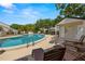 Community pool surrounded by lounge chairs and tables, providing a refreshing space for relaxation and socializing at 4213 Arborwood Ln, Tampa, FL 33618