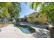 Beautiful backyard with a private pool, brick patio, and lush tropical landscaping at 4521 S Cooper Pl, Tampa, FL 33611
