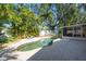 Secluded backyard showcases a refreshing pool surrounded by mature trees and tropical plants at 4521 S Cooper Pl, Tampa, FL 33611