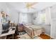 Comfortable bedroom featuring hardwood floors, a ceiling fan, and natural light at 4521 S Cooper Pl, Tampa, FL 33611