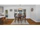 A dining room with wood table, chairs, decorative rug, and modern lighting at 4521 S Cooper Pl, Tampa, FL 33611
