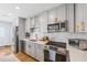 Bright kitchen features stainless steel appliances, modern cabinetry, and a stylish backsplash at 4521 S Cooper Pl, Tampa, FL 33611