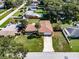 Aerial view of a single-story home with a well-manicured lawn and mature trees in a quiet neighborhood at 5004 S Hesperides St, Tampa, FL 33611
