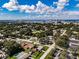 Aerial view of property, mature trees, and city skyline in the background at 5004 S Hesperides St, Tampa, FL 33611