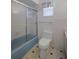 Clean bathroom with shower, toilet, and tiled walls at 5004 S Hesperides St, Tampa, FL 33611