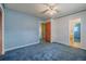 Bedroom featuring light blue patterned walls and light blue carpet with an ensuite bathroom at 5004 S Hesperides St, Tampa, FL 33611