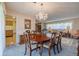 Formal dining room with chandelier and wooden table set, opening up to a comfy living area at 5004 S Hesperides St, Tampa, FL 33611