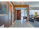 Foyer with tile flooring, wood paneling, and a glimpse into the well-lit, open living space at 5004 S Hesperides St, Tampa, FL 33611