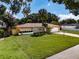 Charming single-story home with well-maintained lawn, mature landscaping, and a spacious two-car garage at 5004 S Hesperides St, Tampa, FL 33611