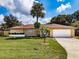 Charming single-story home with well-maintained lawn, mature landscaping, and a spacious two-car garage at 5004 S Hesperides St, Tampa, FL 33611