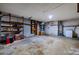 Spacious garage interior featuring concrete flooring, shelving, and lighting at 5004 S Hesperides St, Tampa, FL 33611