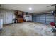 Spacious garage with concrete floor, large garage door and storage shelves at 5004 S Hesperides St, Tampa, FL 33611