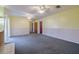 Large, carpeted bonus room perfect for a playroom or casual living area with natural light at 5004 S Hesperides St, Tampa, FL 33611