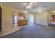 Spacious living room with tile and carpet flooring, connecting seamlessly to the adjacent kitchen area at 5004 S Hesperides St, Tampa, FL 33611