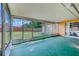 Enclosed patio with screened windows overlooking a large green yard at 5004 S Hesperides St, Tampa, FL 33611