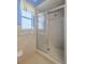 Shower with sliding glass door and tiled walls at 5004 S Hesperides St, Tampa, FL 33611