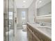 Bathroom with a glass-enclosed shower, double sink vanity, and modern lighting at 521 51St S Ave, St Petersburg, FL 33705