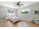 Bright bedroom with hardwood floors, a ceiling fan, and large windows at 521 51St S Ave, St Petersburg, FL 33705