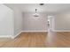 Spacious dining room with light wood floors and modern chandelier, perfect for entertaining at 521 51St S Ave, St Petersburg, FL 33705