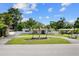 Charming single-story home with a circular driveway and mature palm trees at 521 51St S Ave, St Petersburg, FL 33705