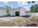 Detached white garage with black garage door and adjacent fenced yard space at 521 51St S Ave, St Petersburg, FL 33705
