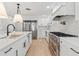 Bright and modern kitchen with stainless steel appliances, quartz countertops and custom cabinetry at 521 51St S Ave, St Petersburg, FL 33705