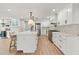 Spacious kitchen features an island with seating, stainless steel appliances, and white cabinetry at 521 51St S Ave, St Petersburg, FL 33705