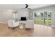 Sun-drenched living room featuring a brick fireplace, comfortable seating, and expansive curved window at 521 51St S Ave, St Petersburg, FL 33705