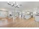 Spacious living room with open floor plan showcasing a brick fireplace and a modern light fixture at 521 51St S Ave, St Petersburg, FL 33705