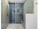 Modern shower featuring blue herringbone tile, mosaic floor, and glass enclosure at 521 51St S Ave, St Petersburg, FL 33705