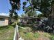 Spacious backyard shaded by a mature tree, presenting an opportunity for landscaping at 6817 S Wall St, Tampa, FL 33616