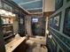 A cozy bathroom with unique wallpaper, offering a canvas for personalized renovation at 6817 S Wall St, Tampa, FL 33616