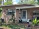 Charming single-story home with a quaint entryway and mature landscaping at 6817 S Wall St, Tampa, FL 33616